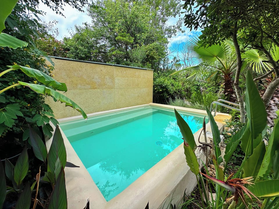 Surrounded by tropical flowers, banana trees, fresh herbs and palm trees...