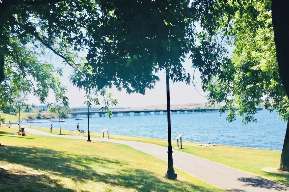View of long paved park walking path accessible by walking from the house