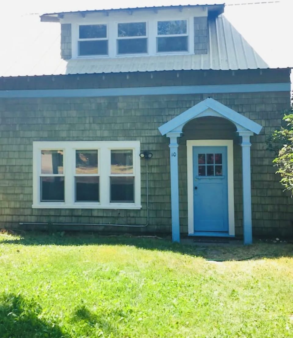 Front view of charming bungalow with decades of character in neighborhood area.