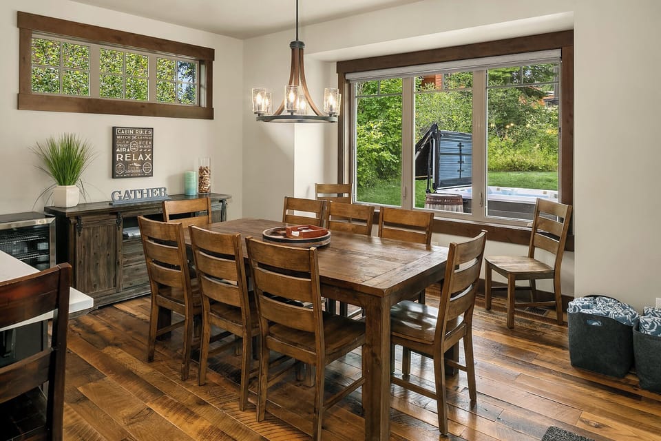 Dining room with 10 chairs as well as a beverage fridge and hot tub towels. 