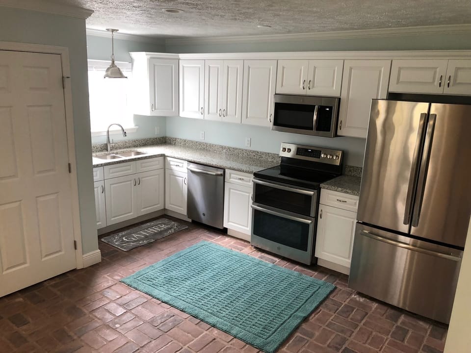 Spacious kitchen with real brick floors. 