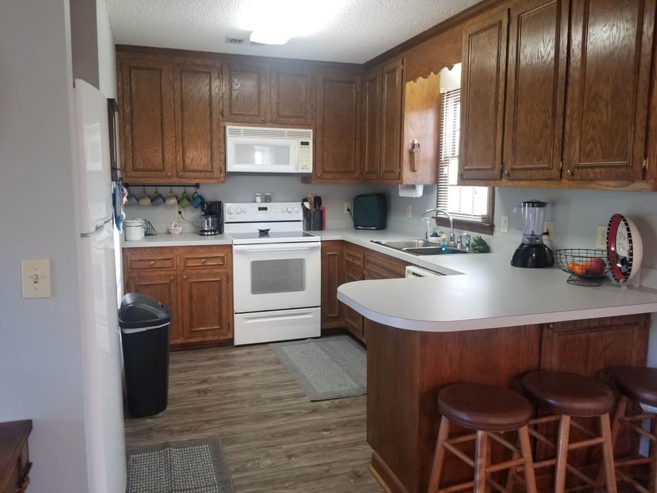 Kitchen has new appliances with all the dishes, pots and utensils 
you need!