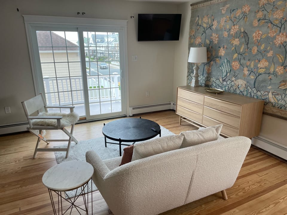 View of master bedroom seating area with patio entrance to private deck 