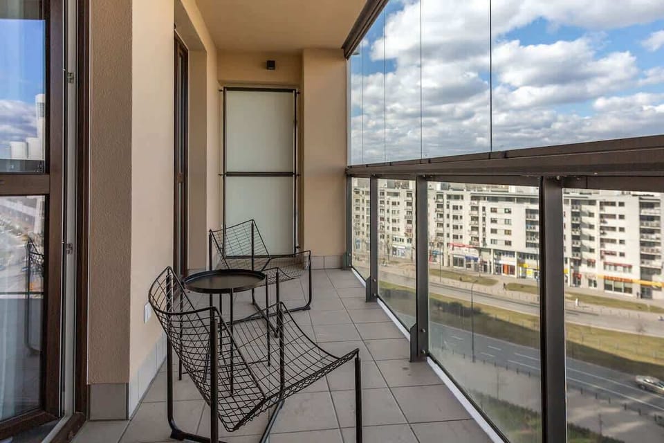 Balcony view with seating, offering a cozy outdoor space attached to the apartment.