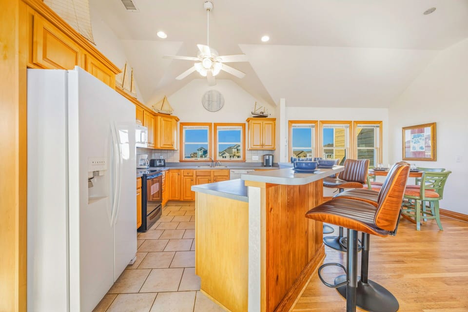 Gather around this spacious kitchen island where you'll craft memorable meals together, with coastal views streaming through every window.
