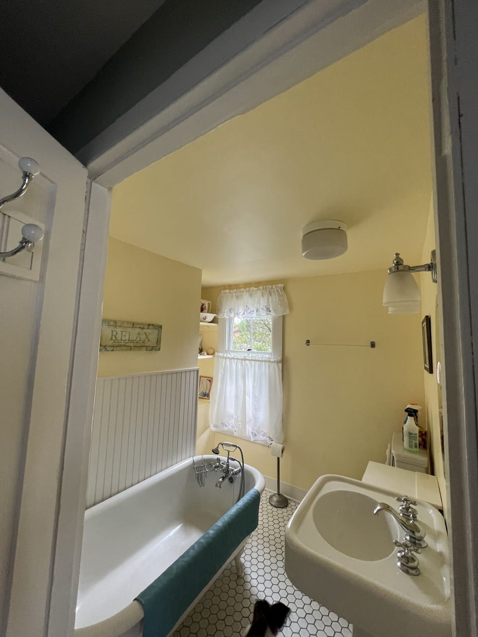 Enter Bathroom with antique claw foot tub.  shower is available outside