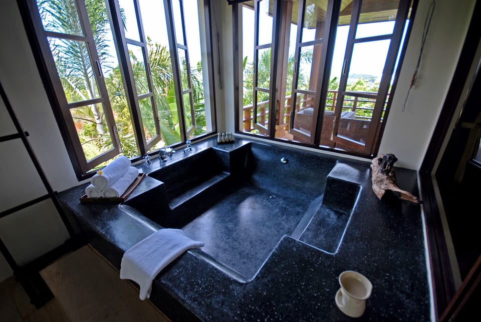 Grand bathrooms fitted with both outdoor or rain showers and large bathtubs
