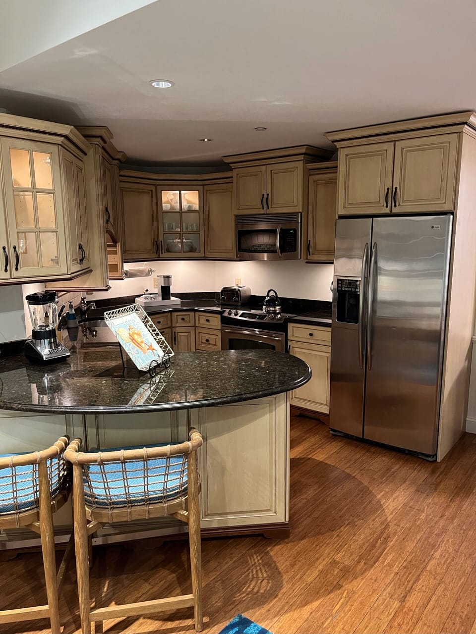 Fully equipped kitchen with wrap-around counter and seating for rour.