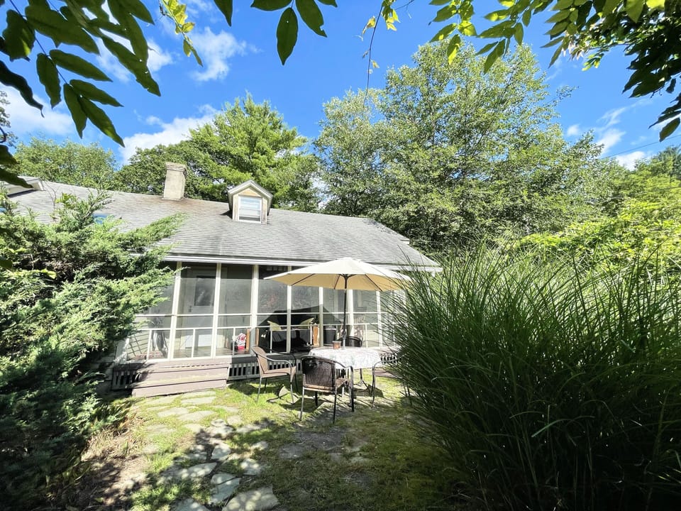Sunny patio with table chairs & Webber Grill