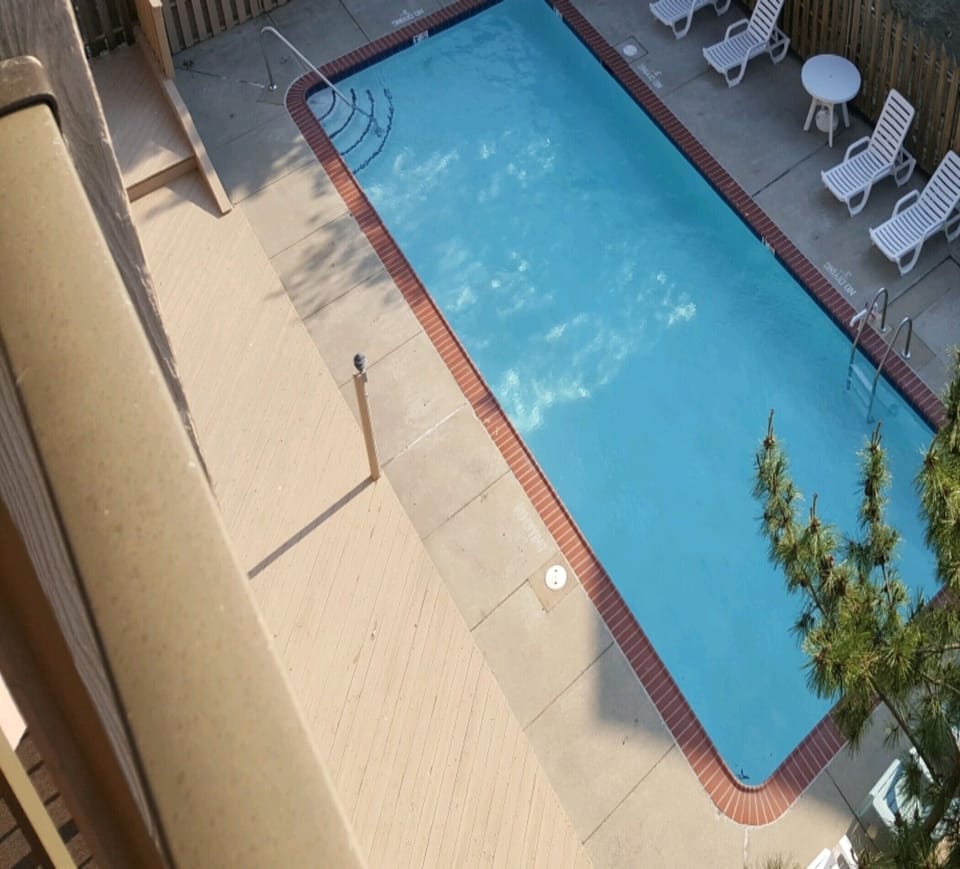 Outdoor pool view from private balcony.
