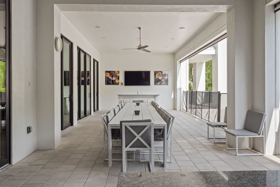 Dine al fresco under the covered lanai. The pool safety fence provides an added layer of protection