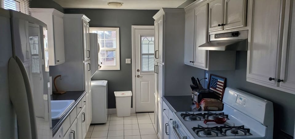 Kitchen with view of back door and laundry.