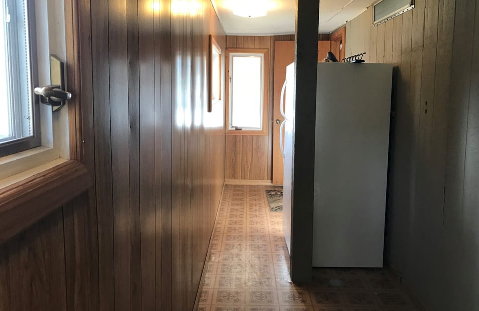 large enclosed entryway with second refrigerator