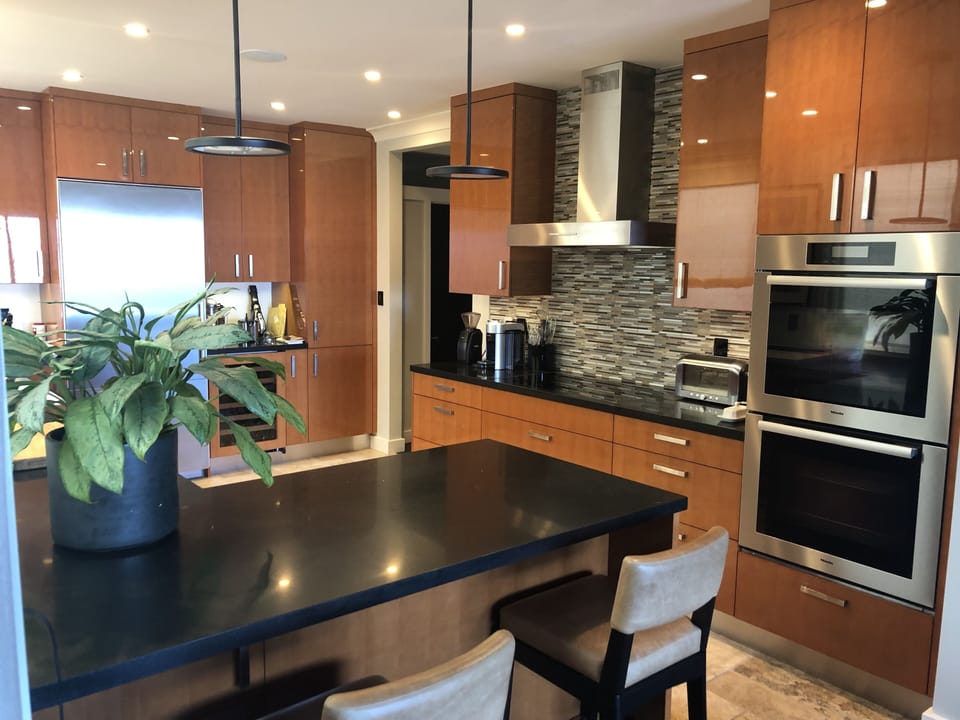 Kitchen with large Miele fridge, induction cooktop and double oven
