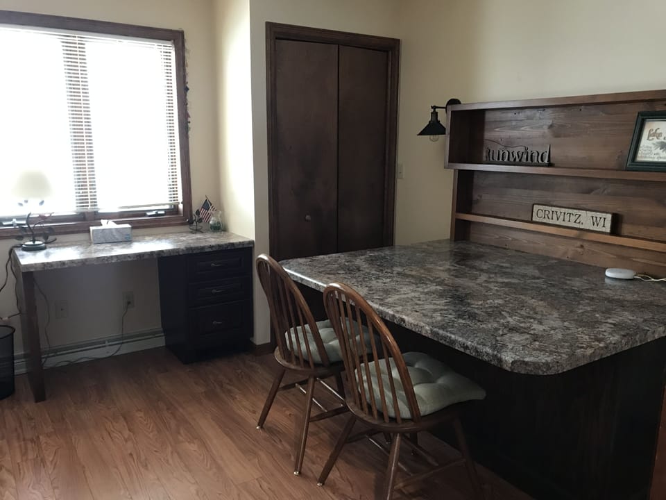 Office with desk and extra seating.