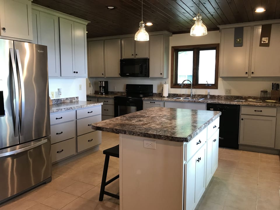 Kitchen with large island for meal prep. Fridge, stove, microwave, dishwasher