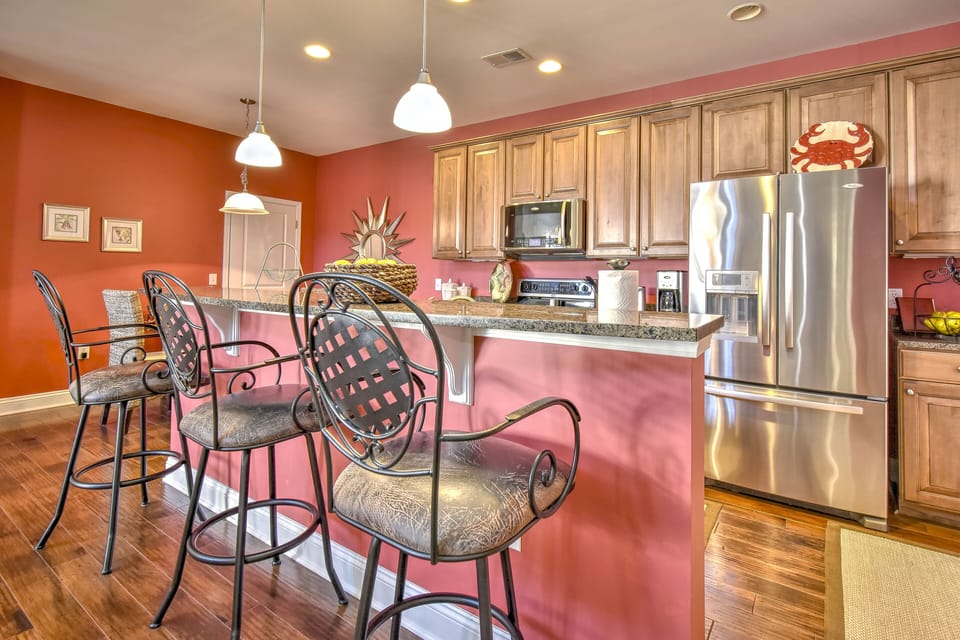 Well-equipped kitchen with counter seating and two dining areas