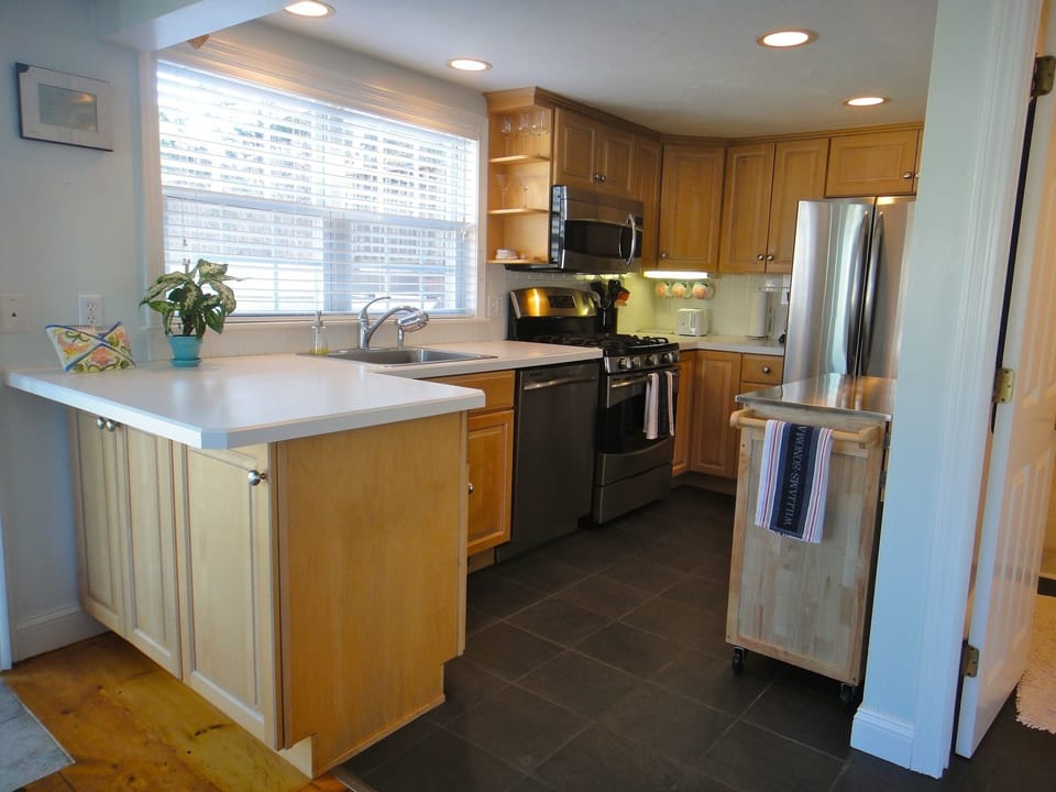 Freshly updated kitchen includes all SS appliances, slate floor and radiant heat