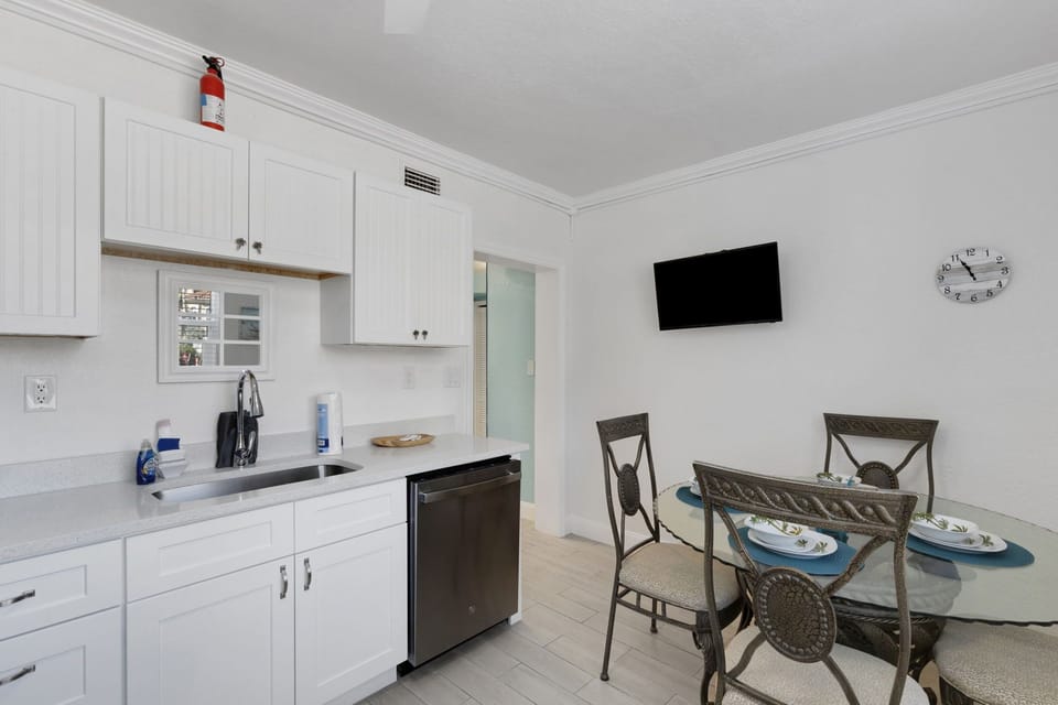 Gourmet Kitchen: Features quartz countertops and sleek white finishes to cook your favorite meals