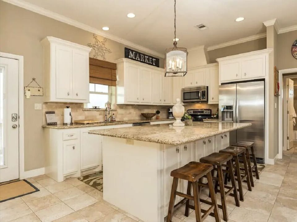 Open concept kitchen, large bar with 4 barstools