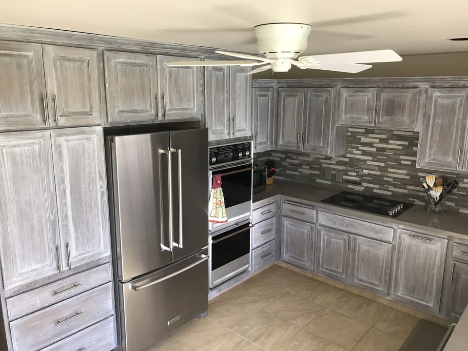 New kitchen - Kitchen Aid stainless steel dishwasher, refrigerator, and cooktop
