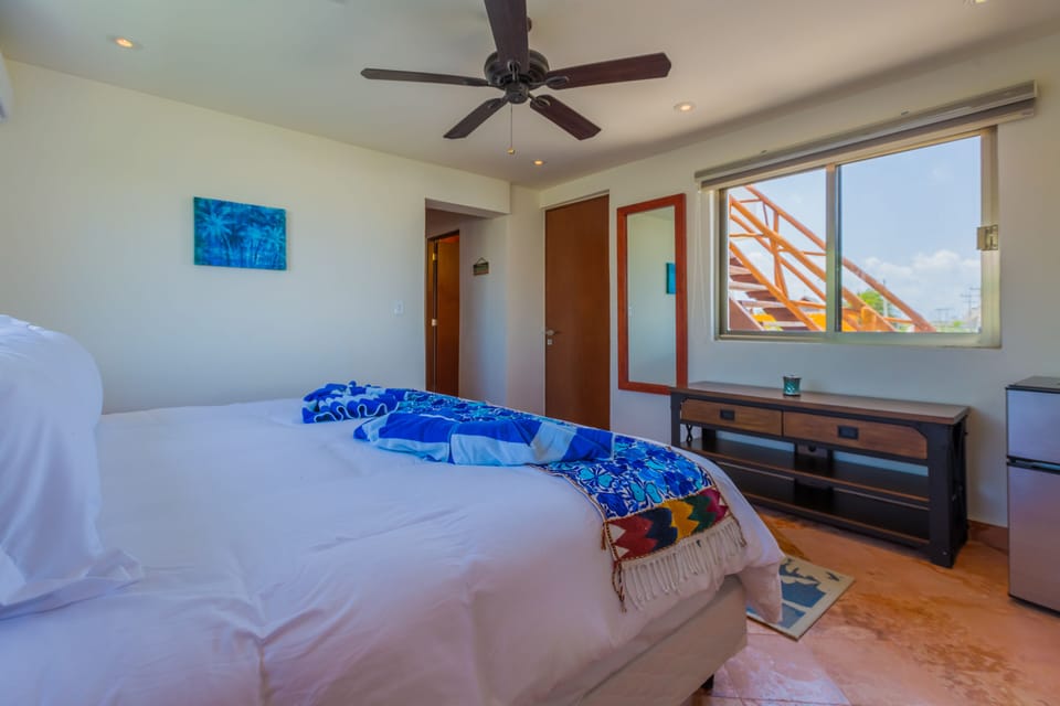 Bedroom with closet, safe & king size bed.
