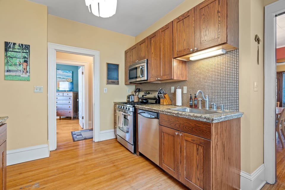 Your fully equipped kitchen features warm wood cabinets, granite counters, and stainless appliances—perfect for preparing meals during your stay.