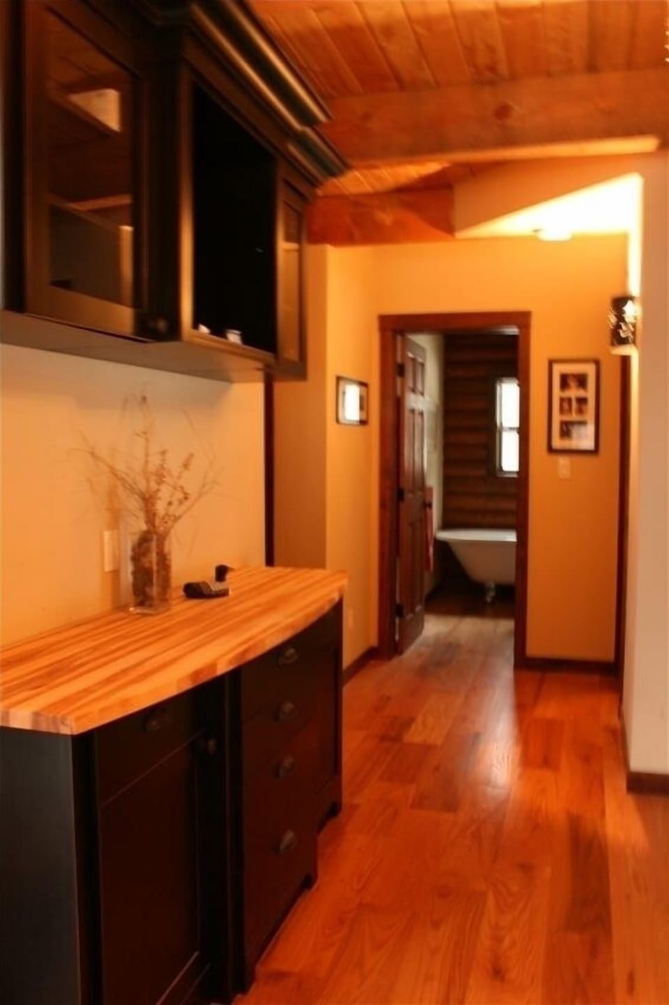 Main floor view to 3 piece bathroom and hutch for additional counter space. 
