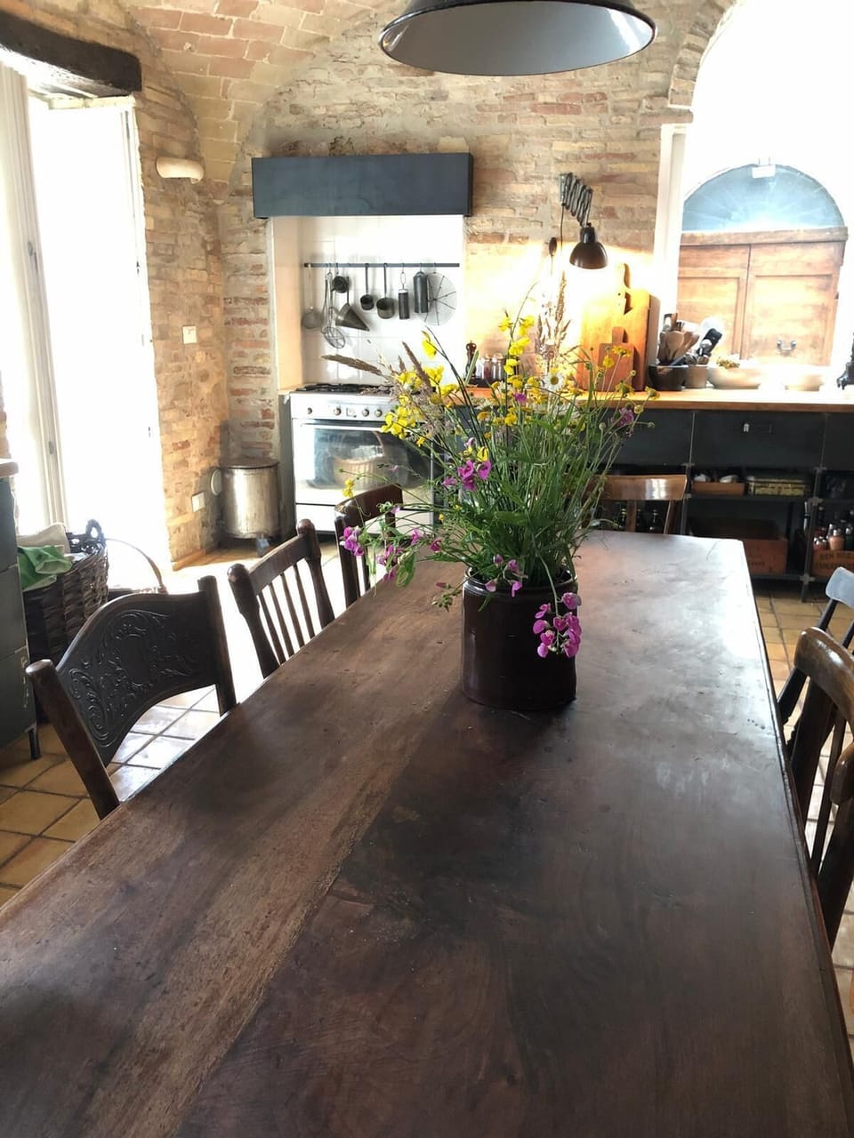 Dining table towards kitchen-terrace door, stove, work bench and window