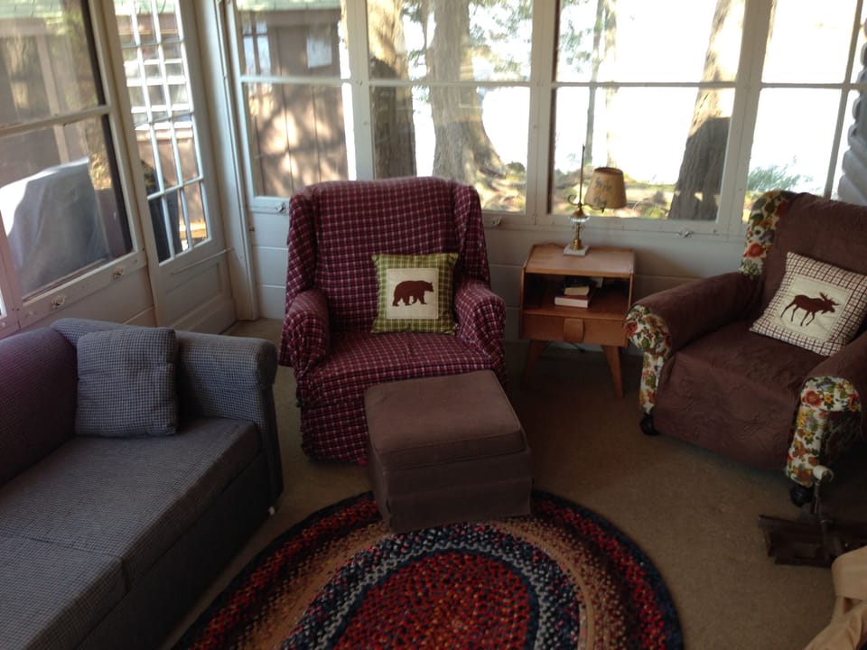 Part of living room area (windows surrounding with view of lake).