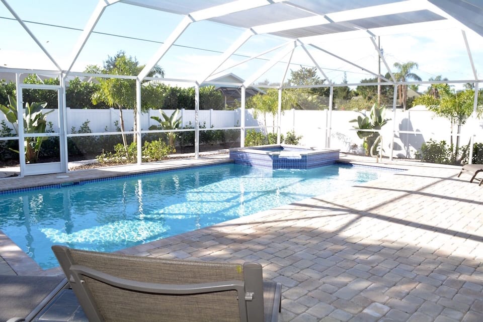 Fenced and screened in heated pool and spa