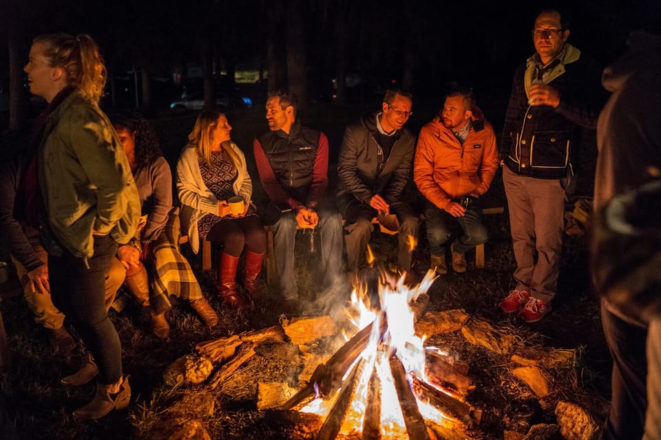 Guests around pavilion campfire circle