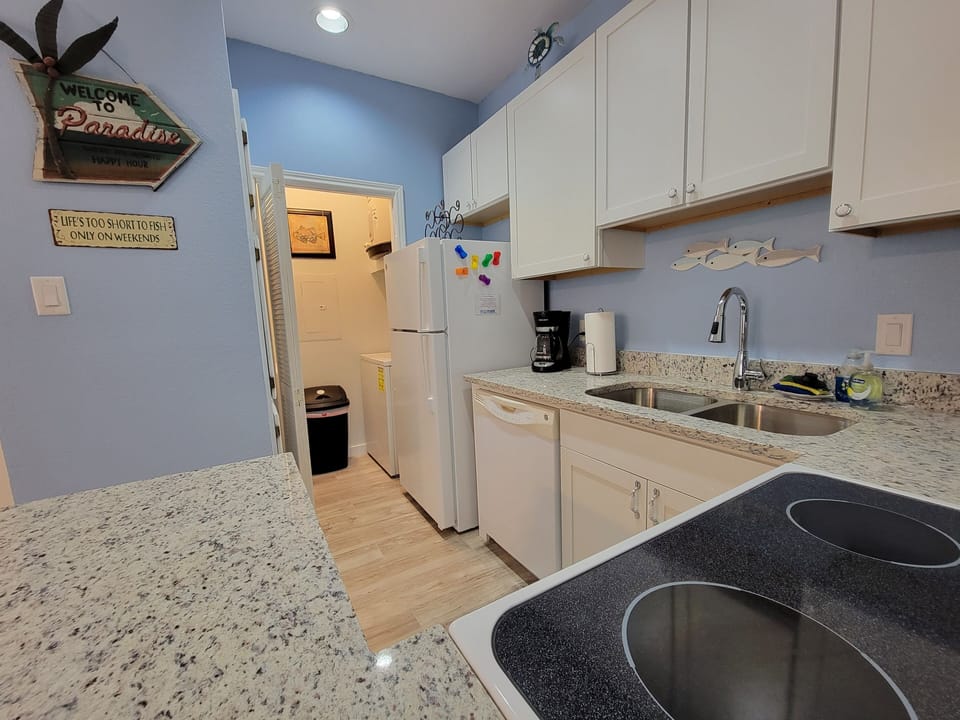 Laundry room next to kitchen