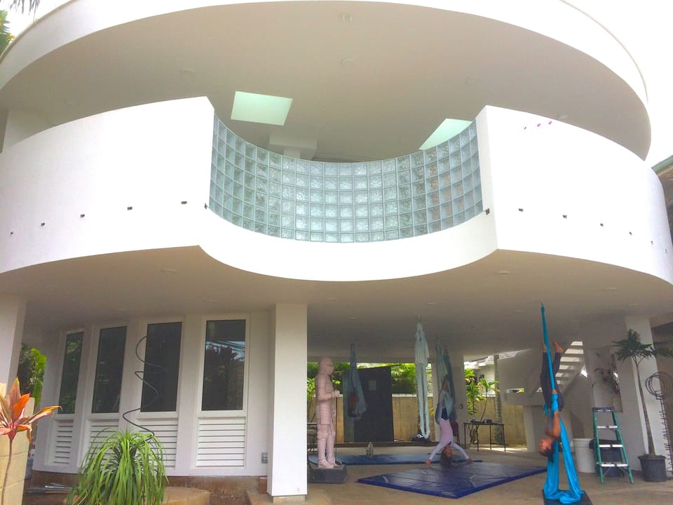 Aerialist practice yoga in the lanai area. Unique beautiful architecture.
