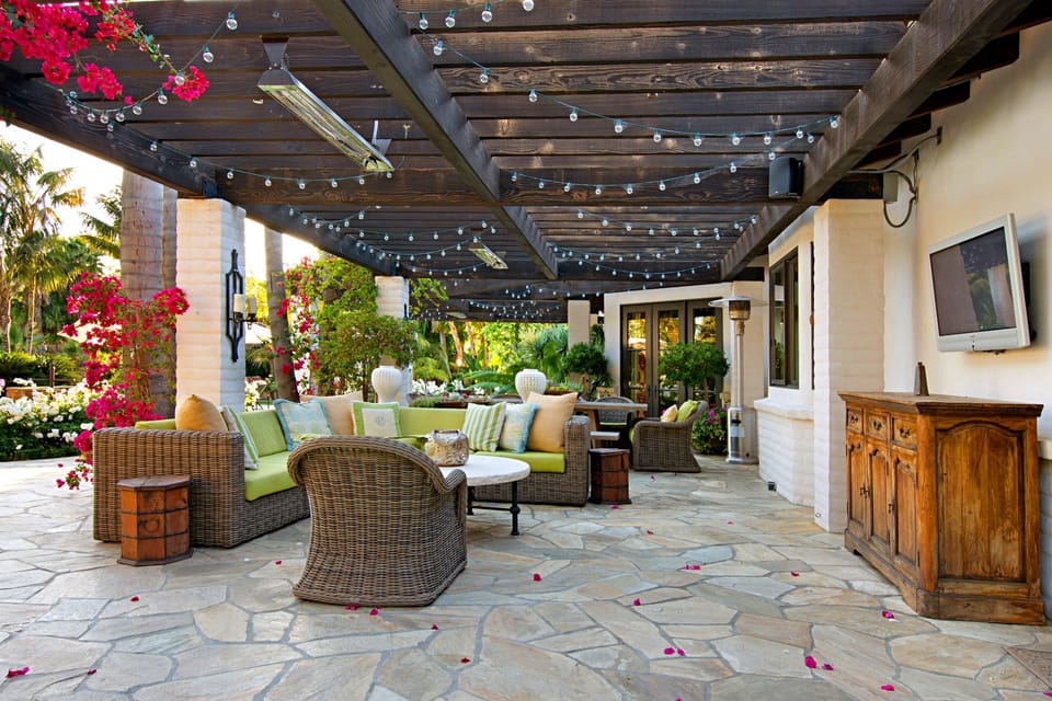 Patio with outdoor television and overhead heaters