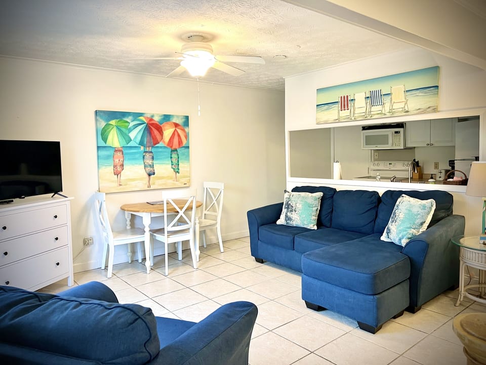 living area with sofa ottoman and chair.
dining and large flat screen TV