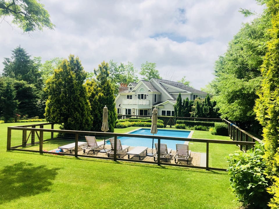 View from back corner of backyard. Pool and space to run around.