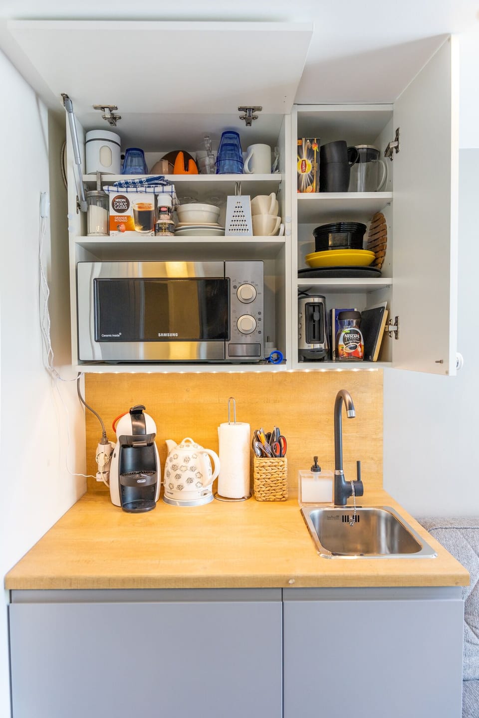 Compact yet stocked: microwave, fridge, coffee, kettle, basics.