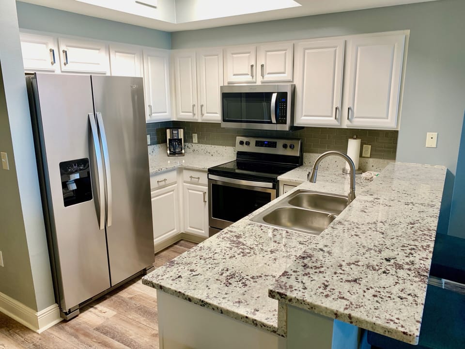 Fully stocked kitchen with all the appliances, dishes, and more.