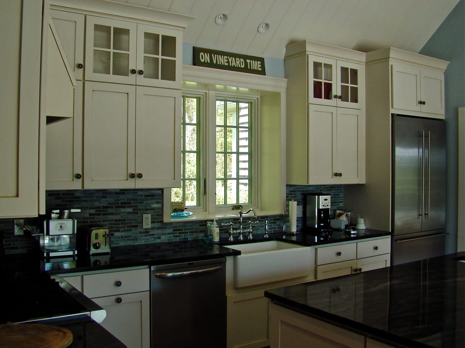 Chef's kitchen with open window looking out to front yard