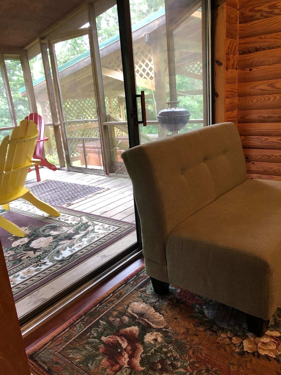 In the bedroom. Looking through screened in porch. Hot tub a few steps away. 