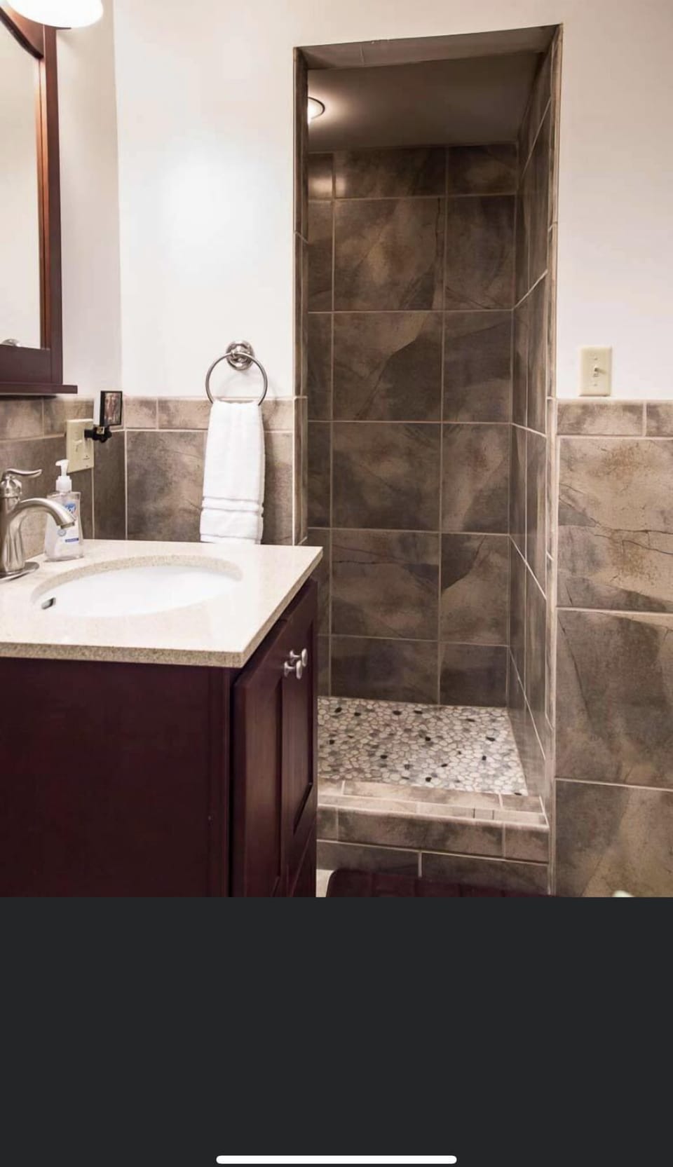 Large, tiled shower.