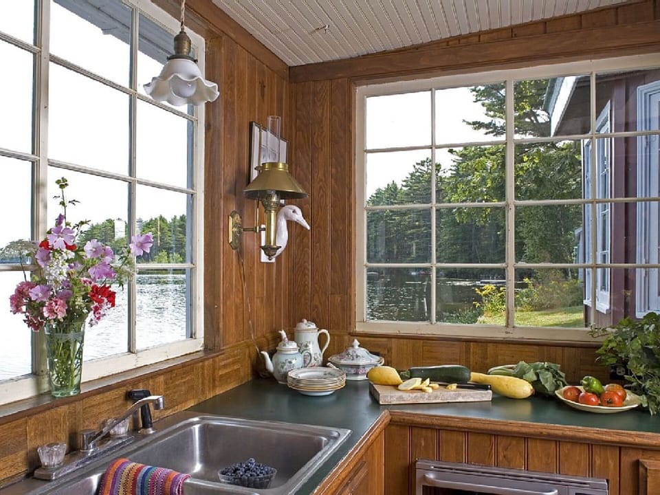 Well appointed Teahouse kitchen overlooking lake. 