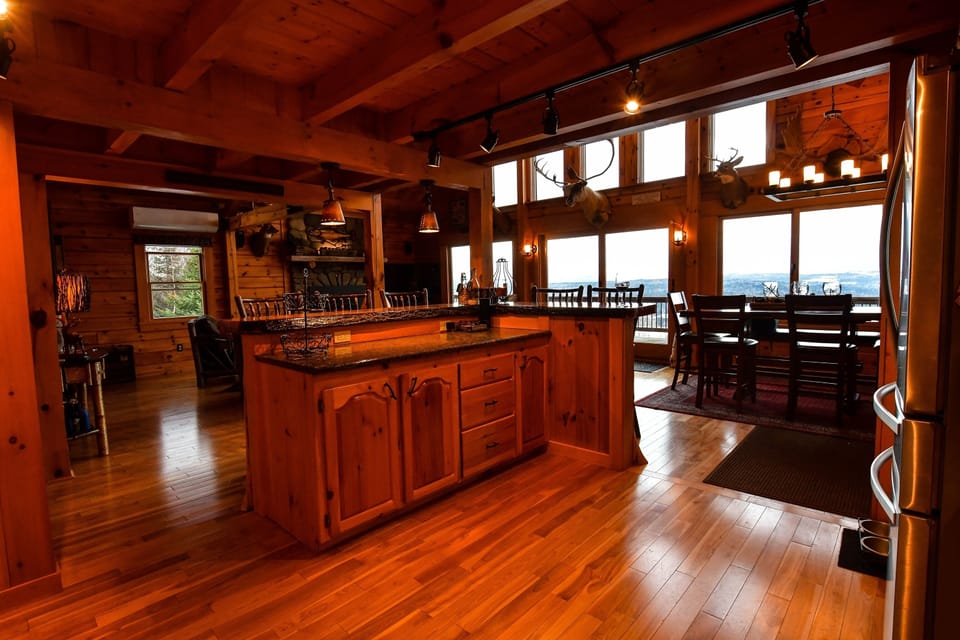 Large kitchen with professional Thermador oven, microwave and bar seating for 5.