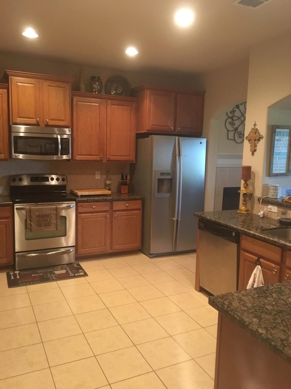 Large open kitchen with stainless steel appliances and most kitchen supplies.