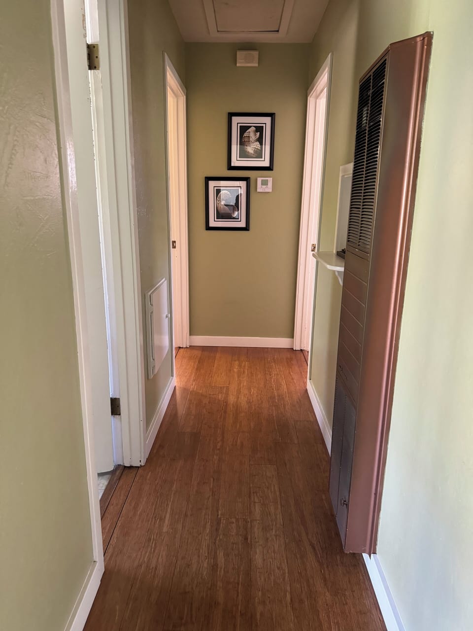 Hallway leading to bathroom and 1st and 2nd bedrooms