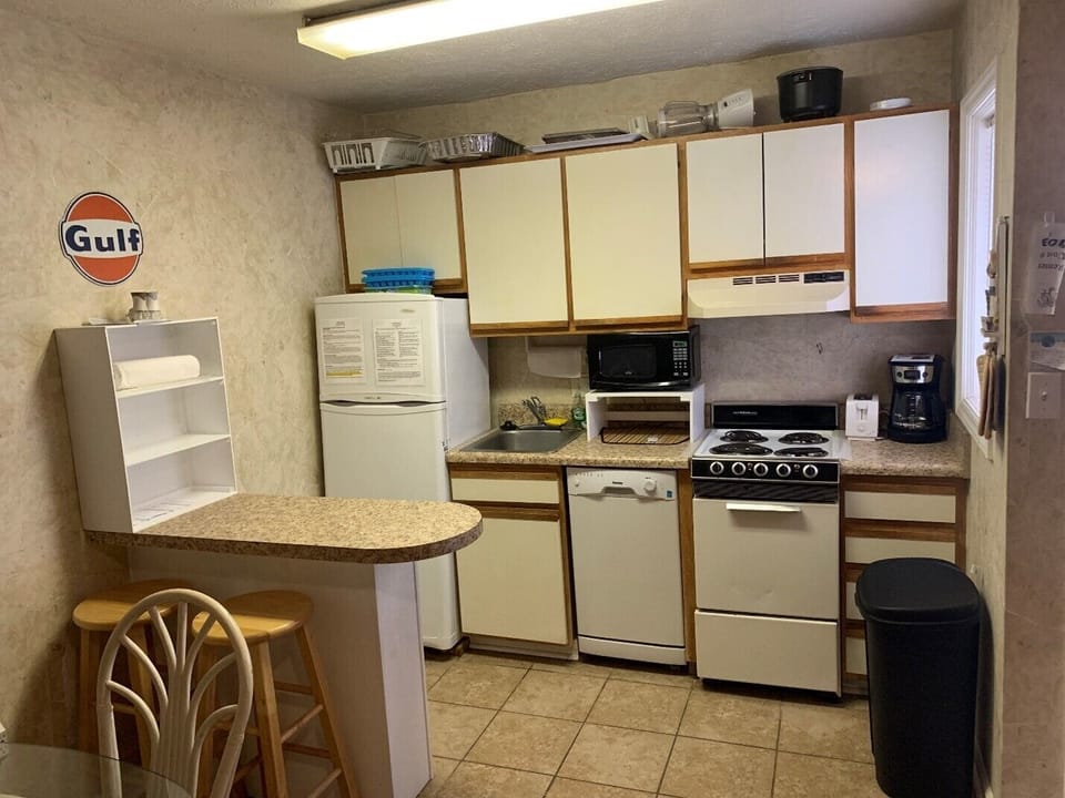 Kitchen - 4 burner stove, oven, dishwasher, coffee maker, pots, pans, utensils