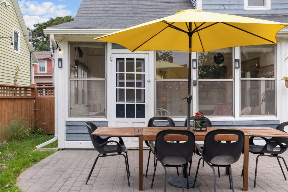 Back stone patio with outdoor dining area.