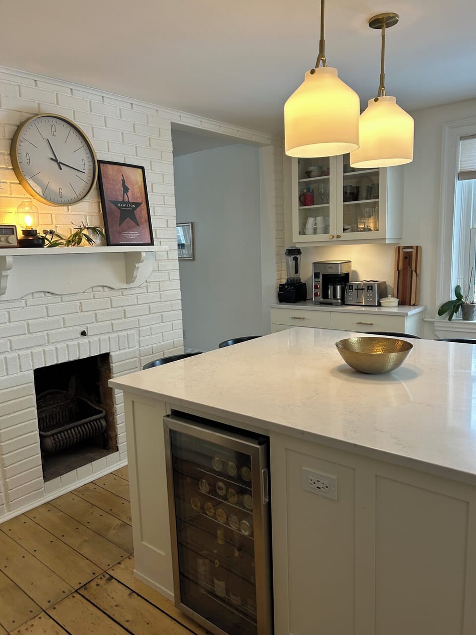 Custom kitchen with high-end appliances and vintage, pine floors. 