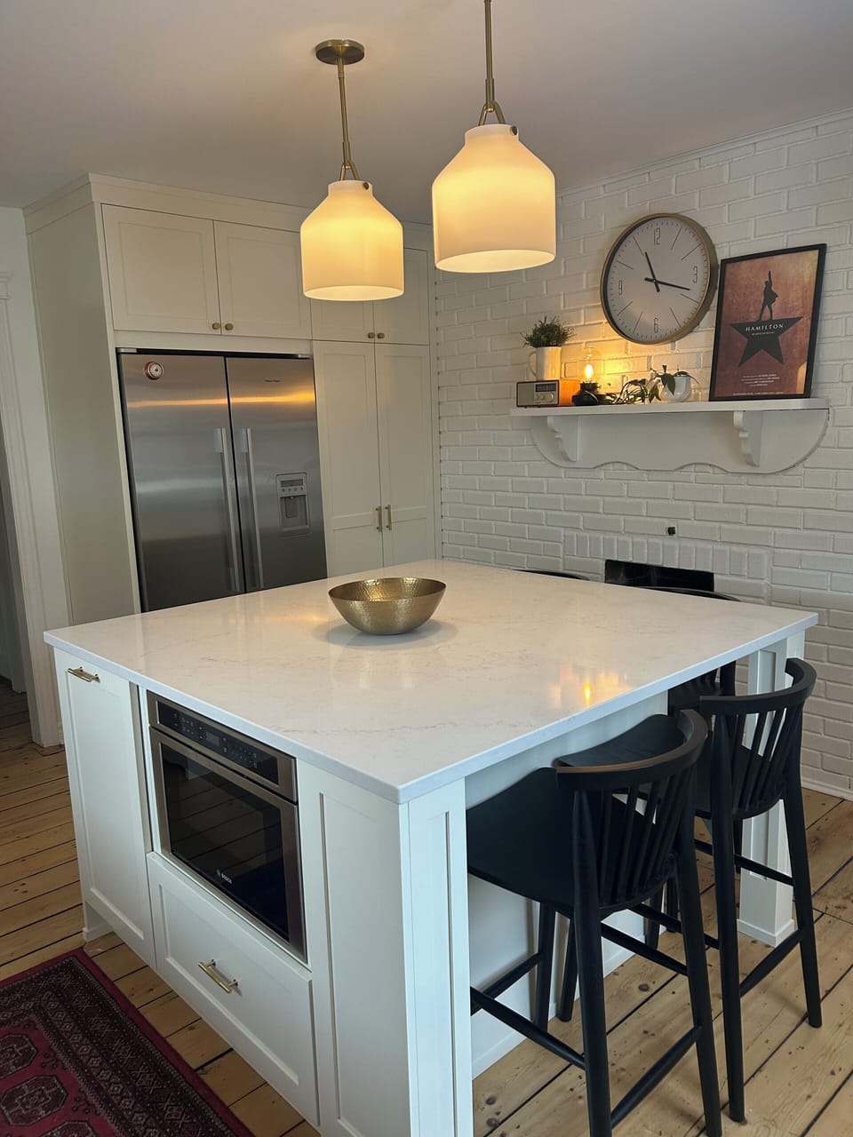Custom kitchen with high-end appliances and vintage, pine floors. 